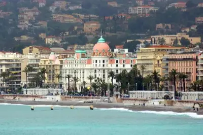 a view of a beach with buildings and the ocean at Negresco Residence Apartment with AC Promenade des Anglais in Nice