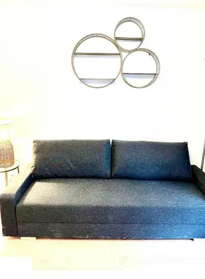 a blue couch with two glasses on the wall at Residence Californie in Nice