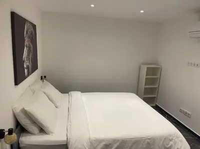 a white bed with white pillows in a bedroom at Nice Proche mer Climatisé 2 pièces style loft in Nice