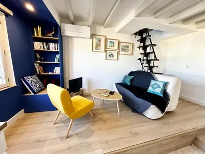 a living room with a couch and a chair at Nice Chateau Duplex Menica vue sur le vieux Nice in Nice