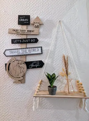a shelf with signs and a plant on a wall at Appartement cosy proche du port in Nice