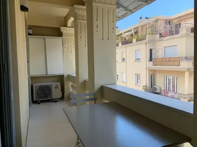 a balcony with a table and a view of a building at T2 Carré D'Or in Nice