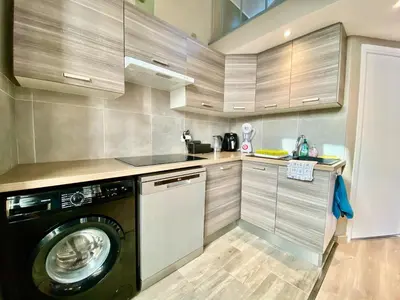 a kitchen with a washer and a washing machine at Lovely & sunny loft heart of Nice with A/C! in Nice