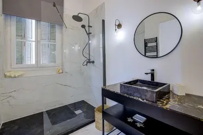 a bathroom with a sink and a mirror at Maison Bianchi - Clemenceau in Nice