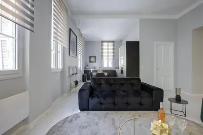 a living room with a couch and a table at Maison Bianchi - Clemenceau in Nice