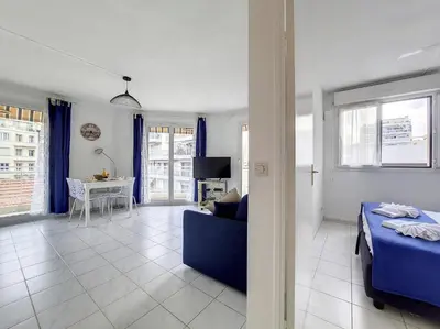 a bedroom with a blue bed and a living room at Nestor&Jeeves - VANINA - Central - Close sea in Nice