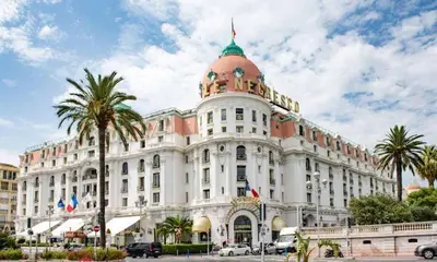 a large white building with a dome on top of it at A Luxurious Apartment with AC on Promenade des Anglais in Nice