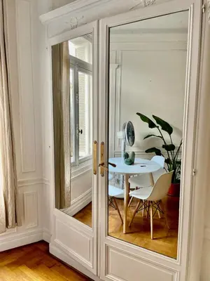a room with a table and a glass door at A Luxurious Apartment with AC on Promenade des Anglais in Nice