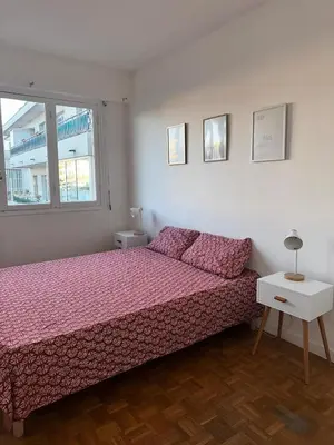 a bedroom with a bed and a window at Orangers Apartment in Nice