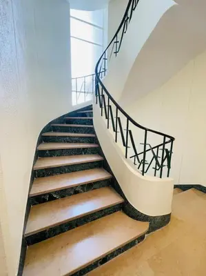 a staircase with a metal railing in a building at T2 Carre Or Nice Rue Pietonne in Nice