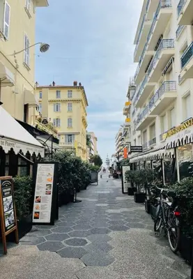 a street in a city with buildings and bikes parked at T2 Carre Or Nice Rue Pietonne in Nice