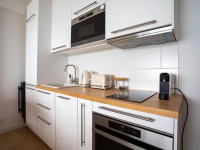 a kitchen with white cabinets and a counter top at Apartment L'Angelina-2 by Interhome in Cagnes-sur-Mer