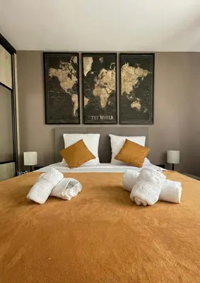 a bedroom with a large bed with two pillows on it at Q&R Renting - Appartement luxueux et Suites design- Parking AC Mer in Nice