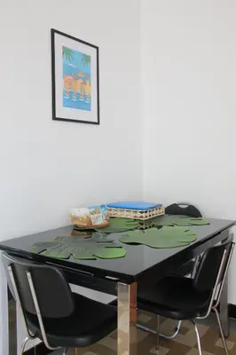 a dining room table with two chairs around it at 2 pièces calme et fonctionnel in Cagnes-sur-Mer