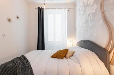 a bedroom with a bed with a mirror on the wall at MY CASA - GESU - 2 bedrooms in Old Town - Gesu Square in Nice