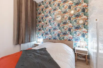 a bedroom with a floral wallpaper on the wall at MY CASA - GESU - 2 bedrooms in Old Town - Gesu Square in Nice