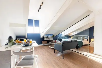 a living room with a bed and a dining room at MY CASA - DEROULEDE - Superb Studio Suite w AC Downtown in Nice