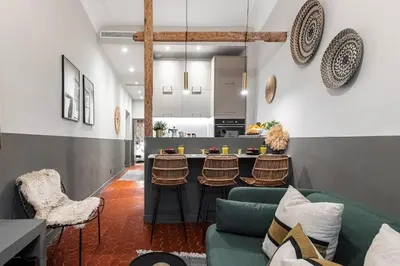 a living room with a green couch and a kitchen at MY CASA - LA CROIX - Old Town Modern apartment - 2 bedrooms in Nice