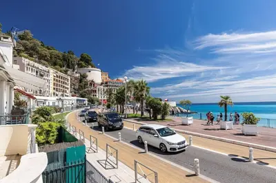 a street in positano with cars parked on the road at MY CASA - PONCHETTES - Independent House Promenade Des Anglais in Nice