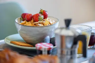 a bowl of cereal with strawberries on a plate at MY CASA - PREFECTURE 15 - Old Town Duplex 2 double beds in Nice