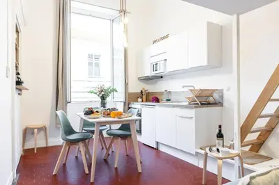 a kitchen with white cabinets and a table and chairs at MY CASA - PREFECTURE 15 - Old Town Duplex 2 double beds in Nice