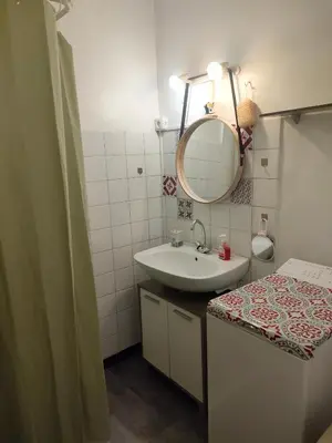 a bathroom with a sink and a mirror at Studio avec balcon à 7 min du port et de Garibaldi in Nice