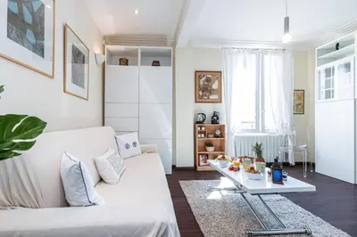 a living room with a white couch and a table at MY CASA - STALINGRAD 32 - Cosy Apartement close old Port in Nice