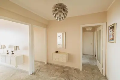 a living room with a chandelier at EXCEPTIONNEL 4 pieces vue panoramique baie des anges proche plage in Nice