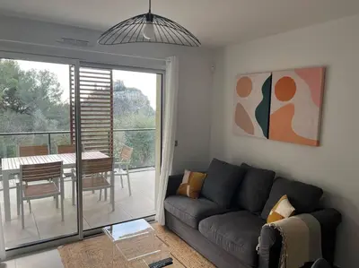 a living room with a couch and a table at Prestige View 411 By Avecoeur in Èze