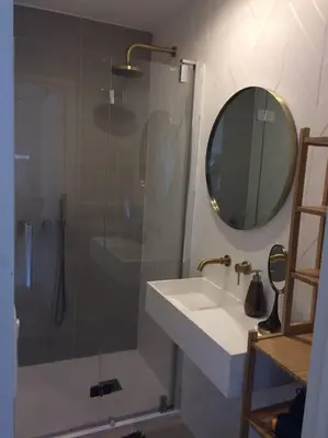 a bathroom with a shower and a sink and a mirror at Lovely Refurbished Apartment in Nice
