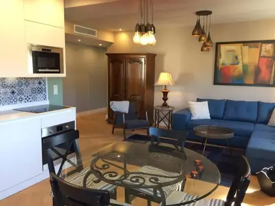 a living room with a blue couch and a table at Lovely Refurbished Apartment in Nice