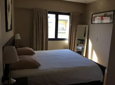 a bedroom with a large bed and a window at Lovely Refurbished Apartment in Nice