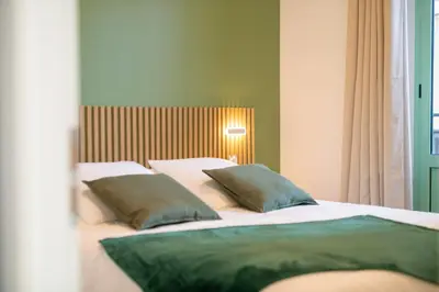 a bedroom with two beds with green pillows at Modern Apartment - Promenade des Anglais in Nice in Nice