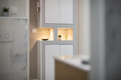 a bathroom with two lights and a counter with plants at Modern Apartment - Promenade des Anglais in Nice in Nice