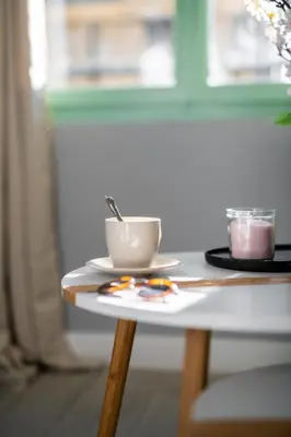 a table with a coffee cup on top of it at Modern Apartment - Promenade des Anglais in Nice in Nice