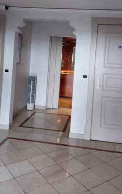 a hallway with a door and a tiled floor at Acquamarina - vue mer in Nice