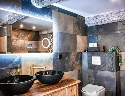a bathroom with two sinks and a toilet at Duplex, jacuzzi, terrasse sur les toits in Nice