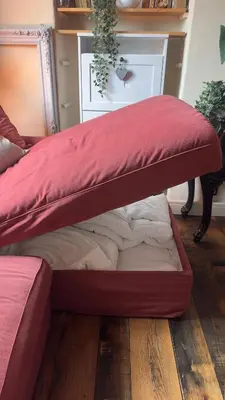 a bed with a red cover on top of it at Duplex, jacuzzi, terrasse sur les toits in Nice