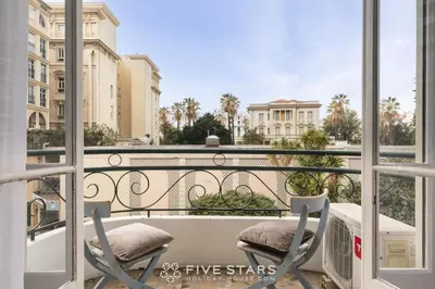 a balcony with two chairs and a table on a balcony at Suite Flora Five stars Holiday house in Nice