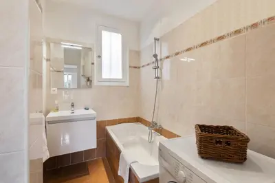 a bathroom with a sink and a toilet and a tub at Suite Flora Five stars Holiday house in Nice