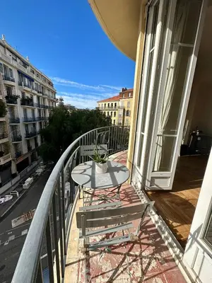 a table on the balcony of a building at Nice 56m with balcony in rotunda near the sea in Nice
