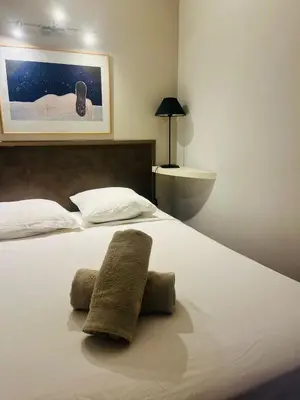 a bedroom with a bed with two towels on it at Vieux Nice 2 pièces Appartement MONACO in Nice