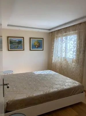 a bedroom with a large bed and a window at Cagnes-sur-Mer, 50m de la mer, au calme in Cagnes-sur-Mer