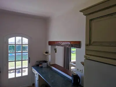 a kitchen with a counter top and a window at Villa Olivaie St Ange in La Gaude