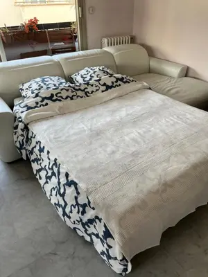 a large bed in a room with a couch at Chambre privée avec terrasse au port de Nice in Nice
