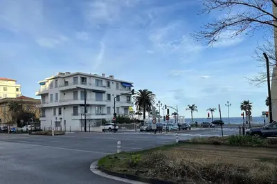 a white building sitting on the side of a street at Magnifique studio au bord de mer in Nice