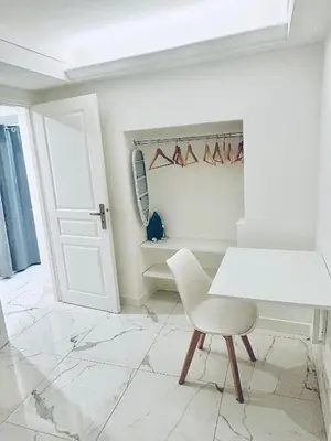 a white room with a white chair and a door at T3 carré d’or plein centre in Nice