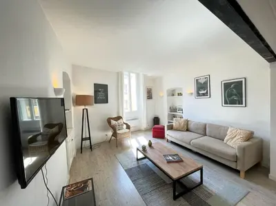 a living room with a couch and a table at Nice Renting - BONAPARTE - Luxury Loft Trendy neighborhood - AC - fully equipped in Nice