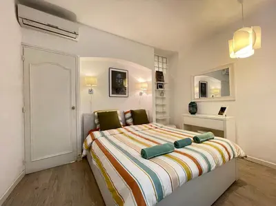 a bedroom with a bed with a colorful striped blanket at Nice Renting - BONAPARTE - Luxury Loft Trendy neighborhood - AC - fully equipped in Nice