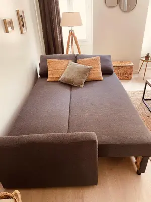 a couch with two pillows on it in a living room at Appartement Carré d’Or Nice in Nice